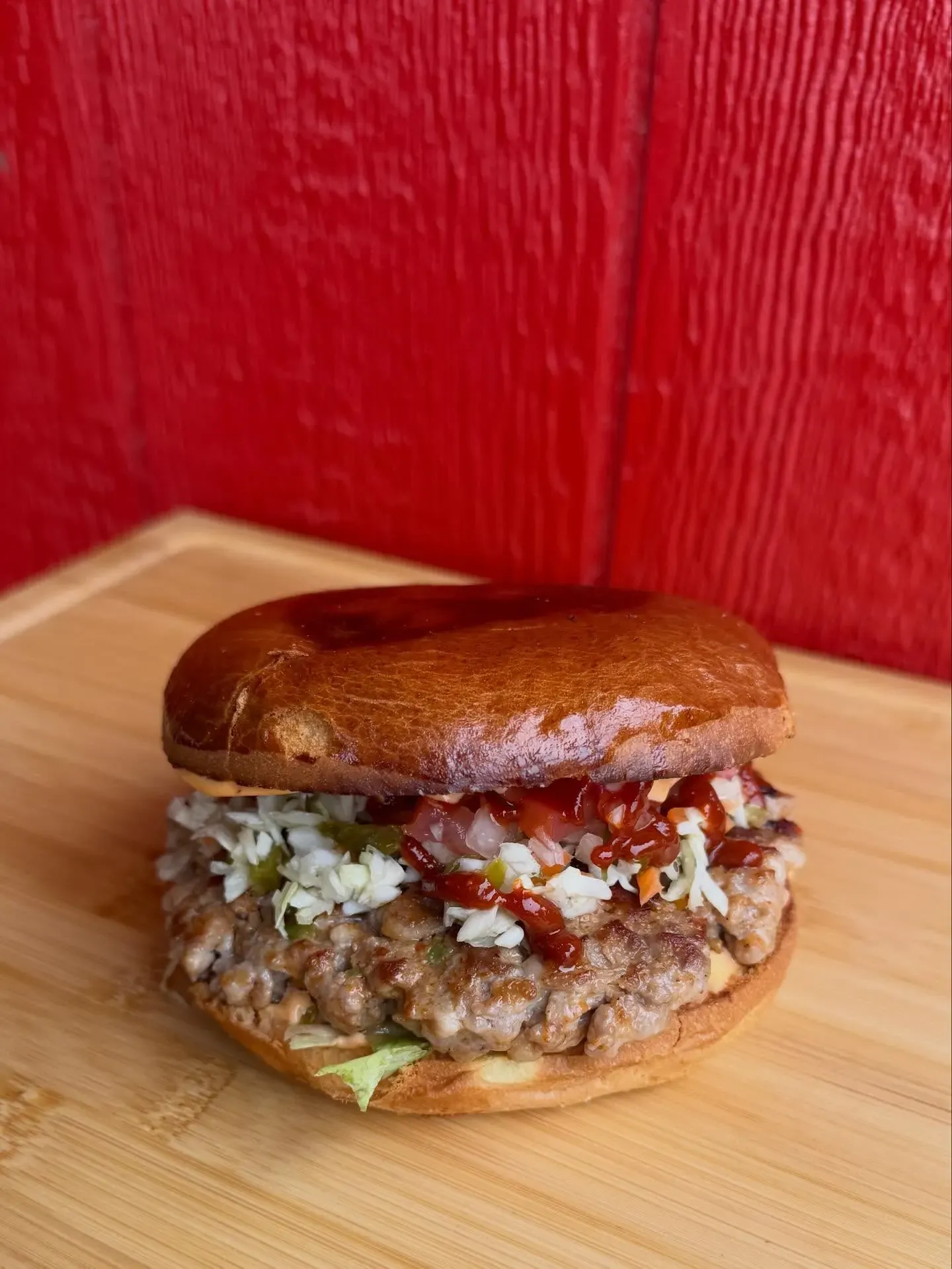 Fat Cat burger with slaw and jalapenos on a brioche bun