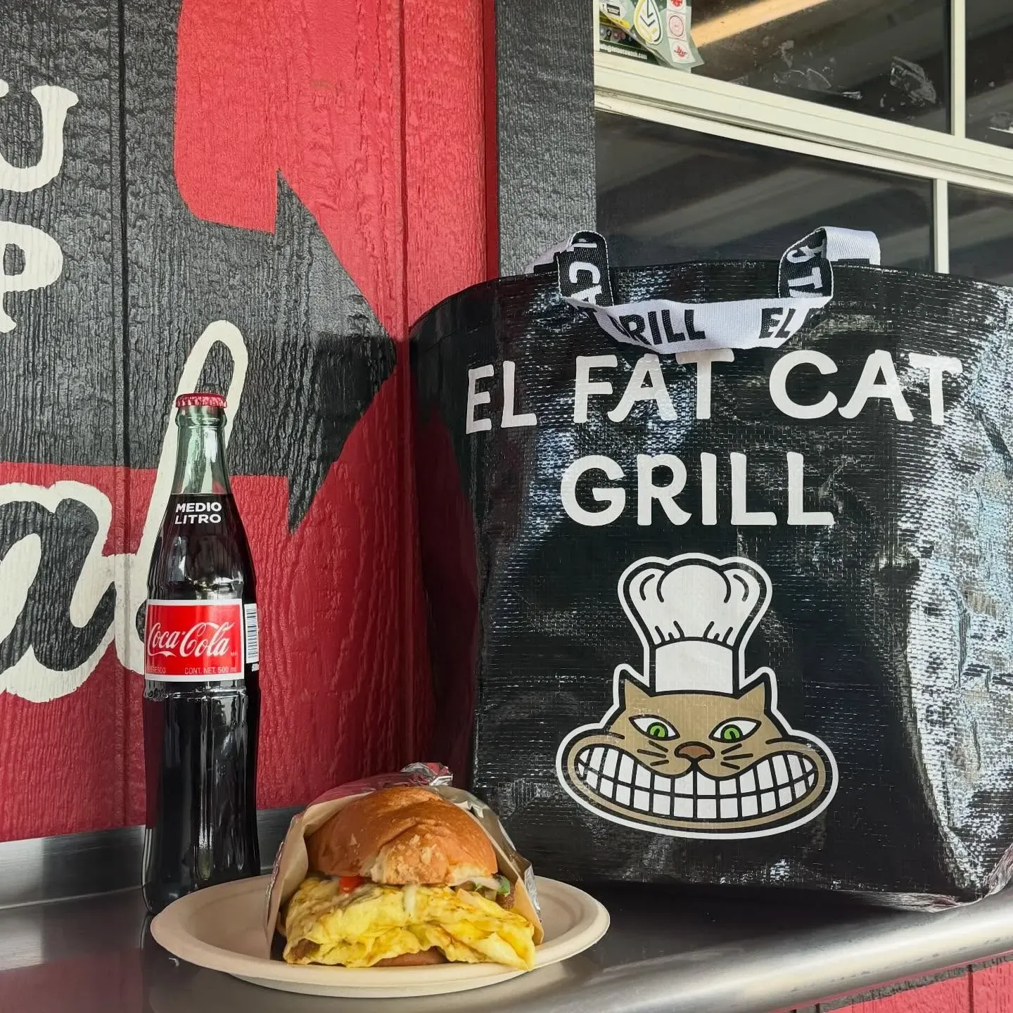 Breakfast torta with a Mexican Coke and an El Fat Cat Grill tote